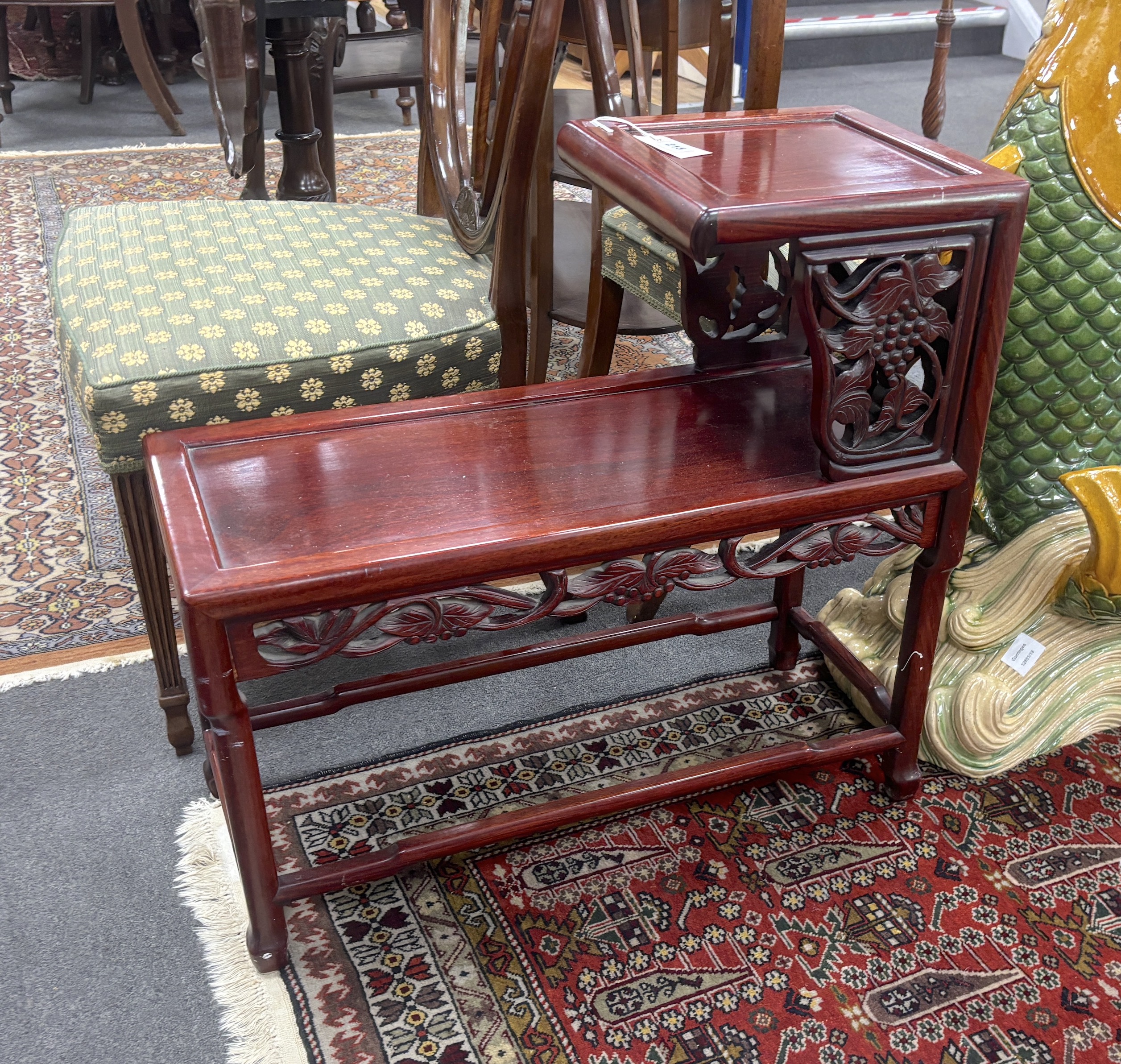 A Chinese carved hardwood two tier table, width 71cm, depth 30cm, height 66cm